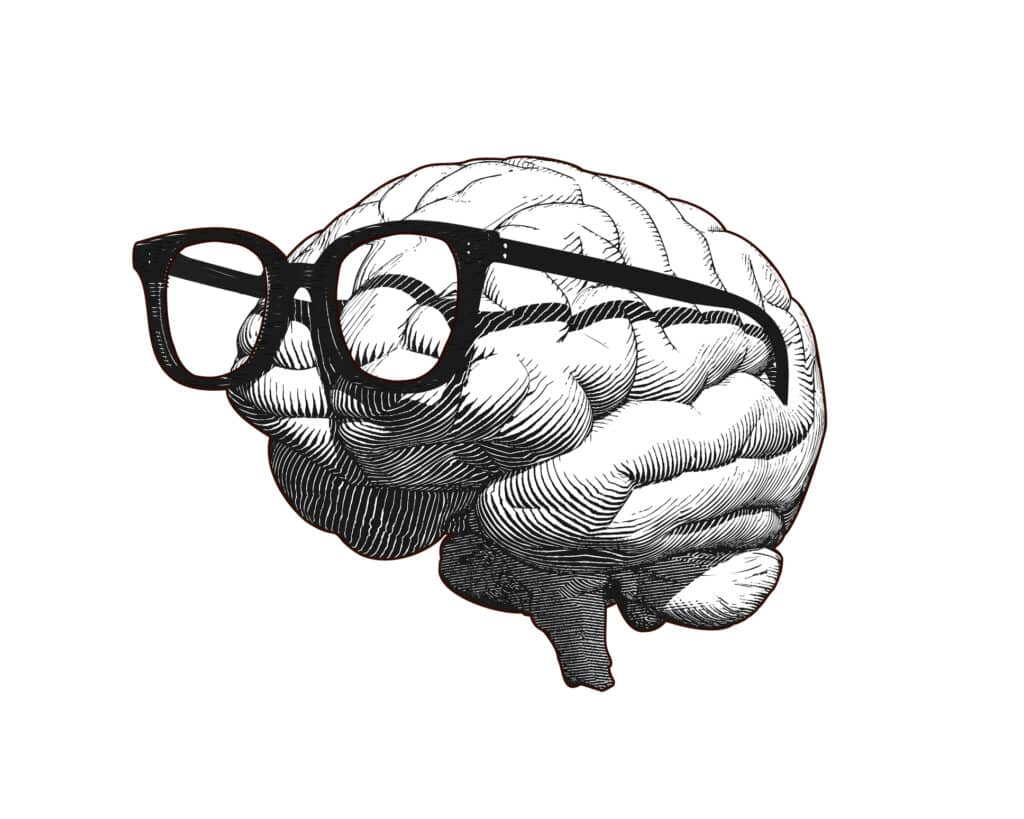 Monochrome, retro engraving of a human brain wearing old, retro glasses, illustrated in side view and isolated on a white background.