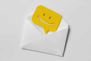 Email envelope with smiling message bubble on white background.