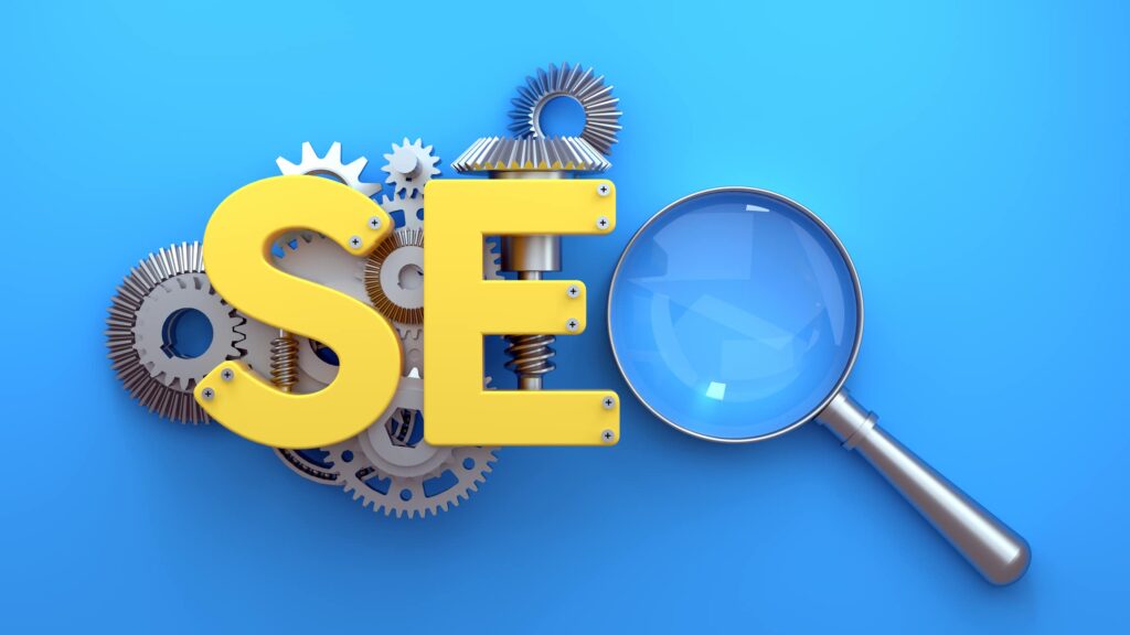 SEO written out with a metal "S" and "E" screwed to a series of cogs and gears, with a magnifying glass as a the "O" beside them.